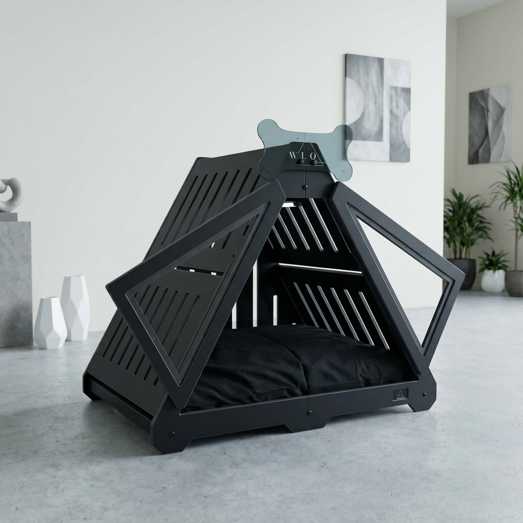 Black pet playpen with cushion on a light gray floor in a room with white walls and decorative plants.