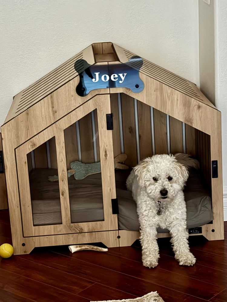 A customer’s Gabled dog house in Natural Oak, Size 2. Customer photo from a review, Aug 2026.